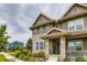 Inviting exterior of a two-story home featuring a covered porch and lush landscaping at 5975 Hanover St, Denver, CO 80238