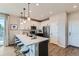 Modern kitchen featuring white cabinets, stainless steel appliances, and a breakfast bar with seating at 5975 Hanover St, Denver, CO 80238