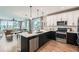 Open kitchen design with stainless steel appliances and sightlines to the living and dining area at 5975 Hanover St, Denver, CO 80238