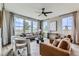 Bright living room with ample natural light, stylish furniture, and modern ceiling fan at 5975 Hanover St, Denver, CO 80238