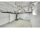 Unfinished basement with water heater, utility sink and white painted ceiling at 16130 Mt Vernon Rd, Golden, CO 80401