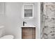 Modern bathroom with sleek vanity, lighted mirror, and marble-look tile shower at 16130 Mt Vernon Rd, Golden, CO 80401