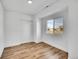 Bright bedroom featuring wood floors, a closet, and natural light from the window at 16130 Mt Vernon Rd, Golden, CO 80401