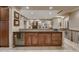 Stylish bar area with dark cabinets, granite countertops, and a built-in wine fridge, perfect for entertaining at 2988 Rockbridge Dr, Highlands Ranch, CO 80129