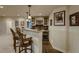 Basement bar area with pendant lighting, seating for three, and a wine refrigerator at 2988 Rockbridge Dr, Highlands Ranch, CO 80129