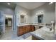 Spacious bathroom with dual sinks, a vanity, and a walk-in closet entrance at 2988 Rockbridge Dr, Highlands Ranch, CO 80129