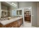 Bathroom view featuring a glass shower, sink with a large mirror and a built-in vanity at 2988 Rockbridge Dr, Highlands Ranch, CO 80129