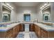 Bright bathroom featuring dual sinks, granite countertops, and ample cabinet space at 2988 Rockbridge Dr, Highlands Ranch, CO 80129