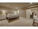 Finished basement bedroom features neutral tones, a double bed, and a rocking chair at 2988 Rockbridge Dr, Highlands Ranch, CO 80129