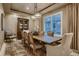 Elegant dining room with wood table, decorative chandelier, and neutral color scheme at 2988 Rockbridge Dr, Highlands Ranch, CO 80129