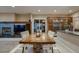 Formal dining area with hardwood table, comfortable seating, and a view of the living room fireplace at 2988 Rockbridge Dr, Highlands Ranch, CO 80129