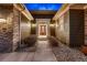 Inviting front entrance featuring a stylish wood door, stone accents, and lovely landscaping at 2988 Rockbridge Dr, Highlands Ranch, CO 80129