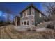 Charming home exterior featuring stone accents, a manicured lawn, and a covered patio area at 2988 Rockbridge Dr, Highlands Ranch, CO 80129