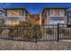 Beautiful home exterior with a stone facade, an upper deck, and a wrought iron fence at 2988 Rockbridge Dr, Highlands Ranch, CO 80129