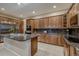 The kitchen features stainless steel appliances, dark granite countertops and wood cabinets at 2988 Rockbridge Dr, Highlands Ranch, CO 80129