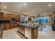 An open-concept kitchen features a central island, granite countertops, and scenic views through large windows at 2988 Rockbridge Dr, Highlands Ranch, CO 80129