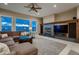 Inviting living room with a large fireplace, comfortable seating, and expansive windows offering scenic views at 2988 Rockbridge Dr, Highlands Ranch, CO 80129