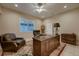 Cozy home office featuring a wooden desk, ceiling fan, and ample natural light at 2988 Rockbridge Dr, Highlands Ranch, CO 80129