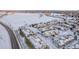 Snow covered townhomes near a lake and highway at 11261 W Quincy Pl, Littleton, CO 80127