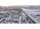Aerial view of townhomes nestled in a winter landscape at 11261 W Quincy Pl, Littleton, CO 80127