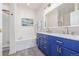 Modern bathroom with a double vanity and a soaking tub at 11261 W Quincy Pl, Littleton, CO 80127