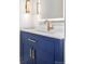 Elegant bathroom vanity with a navy blue cabinet and gold accents at 11261 W Quincy Pl, Littleton, CO 80127