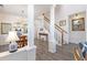 Bright dining room with hardwood floors, chandelier, and views to the living room at 11261 W Quincy Pl, Littleton, CO 80127