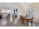 Bright dining room with hardwood floors, a chandelier, and a large table at 11261 W Quincy Pl, Littleton, CO 80127
