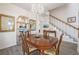 Formal dining room with hardwood floors, a chandelier, and ample seating at 11261 W Quincy Pl, Littleton, CO 80127