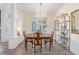 Elegant dining room with hardwood floors, chandelier, and built-in shelving at 11261 W Quincy Pl, Littleton, CO 80127