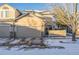 Attached two-car garage with ample parking space and snowy driveway at 11261 W Quincy Pl, Littleton, CO 80127