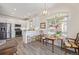Modern kitchen with white cabinets, stainless steel appliances, and breakfast nook at 11261 W Quincy Pl, Littleton, CO 80127