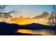 Sunset view over lake with silhouetted mountains at 11261 W Quincy Pl, Littleton, CO 80127