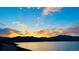 Scenic sunset over calm lake and mountain range at 11261 W Quincy Pl, Littleton, CO 80127