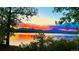 Vibrant sunset colors reflected on tranquil lake at 11261 W Quincy Pl, Littleton, CO 80127