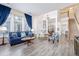 Open concept living area with high ceilings and views of dining and staircase at 11261 W Quincy Pl, Littleton, CO 80127