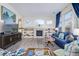 Spacious living room with fireplace, built-in shelving, and large windows at 11261 W Quincy Pl, Littleton, CO 80127