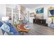 Spacious living room featuring hardwood floors, comfortable seating, and a large TV at 11261 W Quincy Pl, Littleton, CO 80127