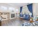 Spacious living room with fireplace, built-in shelving, and large windows at 11261 W Quincy Pl, Littleton, CO 80127