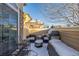 Cozy patio with seating, grill, and snow covering at 11261 W Quincy Pl, Littleton, CO 80127