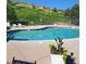 Inviting community pool with lounge chairs and mountain views at 11261 W Quincy Pl, Littleton, CO 80127