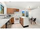 Modern kitchen with wood cabinets, breakfast bar, and stainless steel appliances at 17864 E Prentice Dr, Centennial, CO 80015