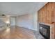 Spacious living area boasting a cozy fireplace with stone surround and wood paneling at 14780 E Kentucky Dr # 432, Aurora, CO 80012