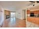 Bright living room with hardwood floors, fireplace, and kitchen at 14780 E Kentucky Dr # 432, Aurora, CO 80012