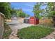 Large backyard with lawn, patio, and multiple sheds at 5515 Dudley Ct, Arvada, CO 80002