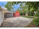 Spacious backyard with a well-maintained lawn, patio, shed, and festive string lights at 5515 Dudley Ct, Arvada, CO 80002