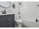 Modern bathroom with a gray vanity, white subway tile, and sleek fixtures at 5515 Dudley Ct, Arvada, CO 80002