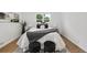 Relaxing bedroom with a plush bed, black ottomans, and an airy ambiance at 5515 Dudley Ct, Arvada, CO 80002