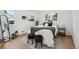 Cozy bedroom featuring natural light, neutral decor, and hardwood floors at 5515 Dudley Ct, Arvada, CO 80002