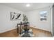 Bright bedroom features a sleek desk, modern decor, and warm, wood-look flooring at 5515 Dudley Ct, Arvada, CO 80002